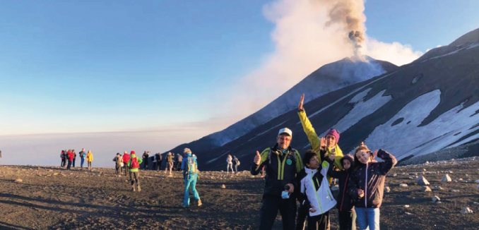 family on top of etna